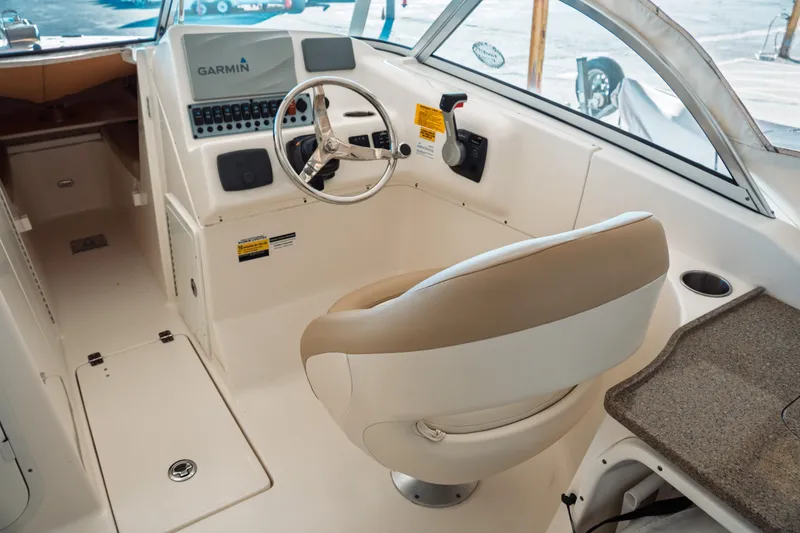 Slide: The Image of 2019 Key West 239 DFS boat cockpit with steering wheel and Garmin navigation system. - 23