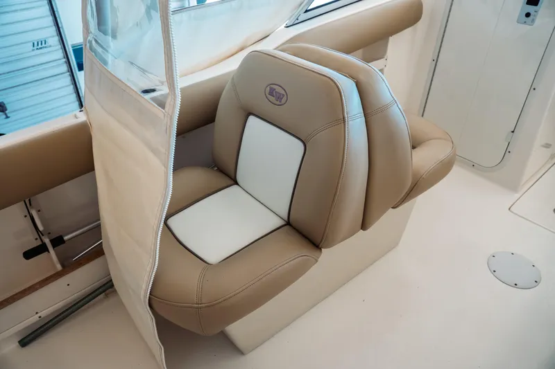 Slide: The Image of 2019 Key West 239 DFS boat seat with tan and white upholstery. - 25