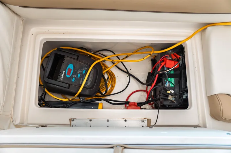 Slide: The Image of Battery compartment of 2019 Key West 239 DFS boat with charger and cables. - 27