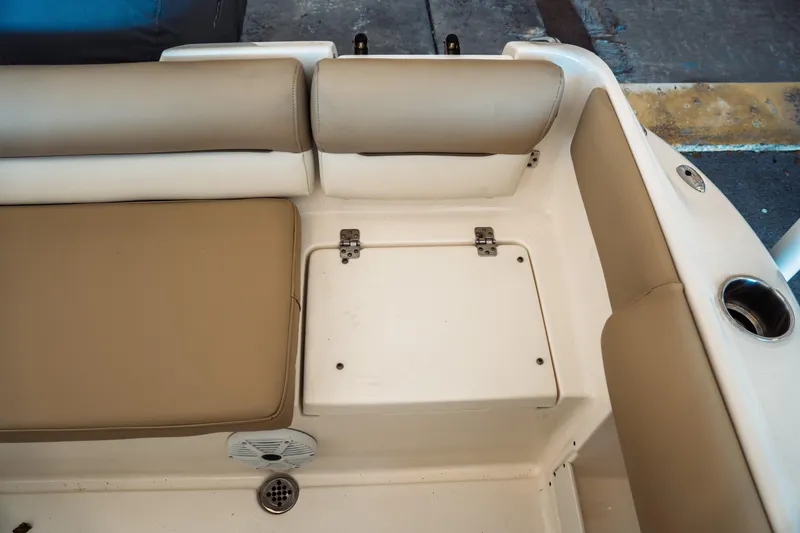 Slide: The Image of Interior seating of 2019 Key West 239 DFS boat with beige cushions and storage compartment. - 29