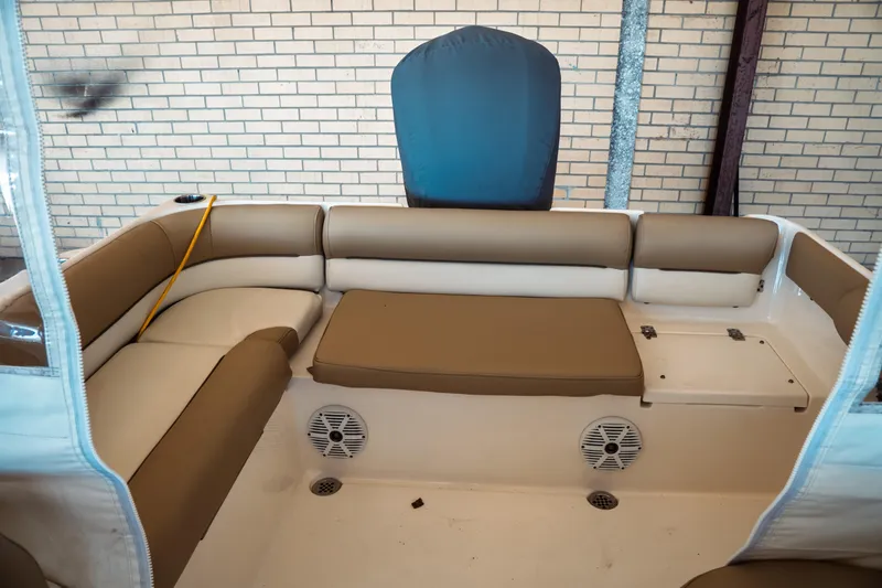 Slide: The Image of 2019 Key West 239 DFS boat interior with tan seating and speakers. - 31
