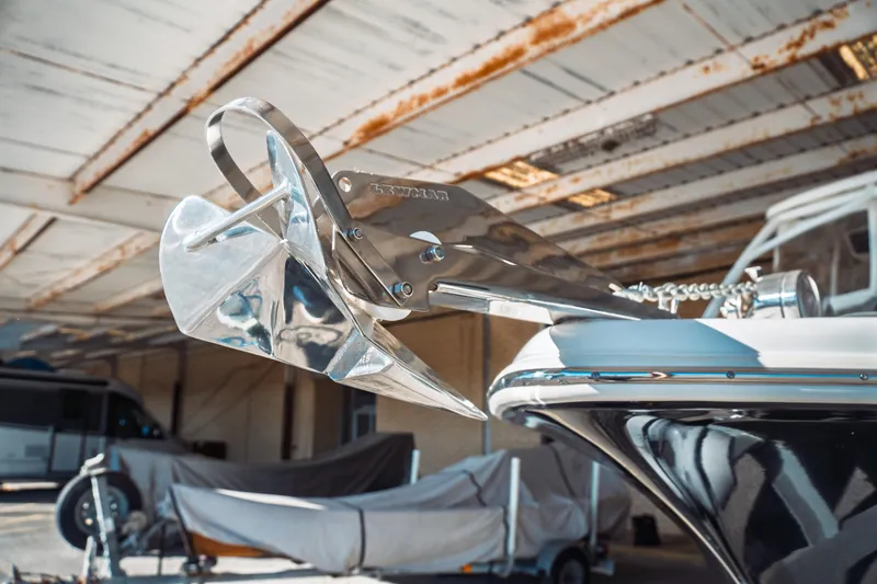 Slide: The Image of 2019 Key West 239 DFS boat with a shiny stainless steel anchor in a covered storage area. - 33