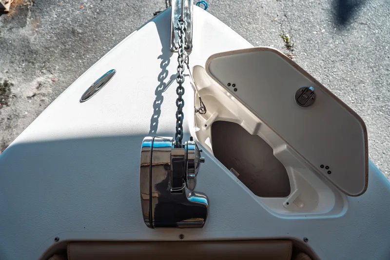 Slide: The Image of 2019 Key West 239 DFS boat anchor compartment with open hatch and chain. - 6