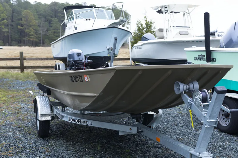 Slide: The Image of 2025 G3 Gator Tough 1652 VBW boat on trailer, parked outdoors. - 4