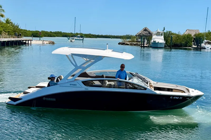 Slide: The Image of 2022 Yamaha Boats 275SD cruising on a sunny day in a scenic waterway. - 10