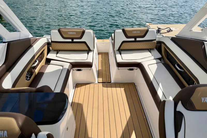Slide: The Image of Luxurious interior of 2022 Yamaha Boats 275SD with elegant seating and teak flooring. - 14