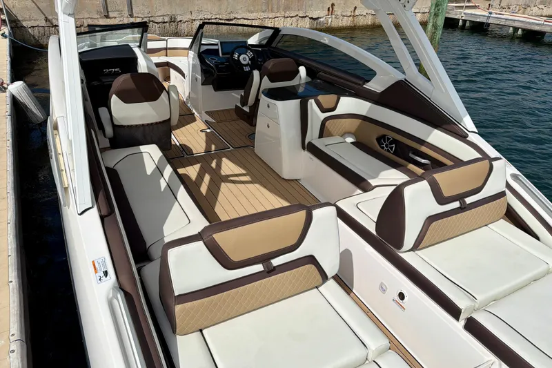 Slide: The Image of 2022 Yamaha Boats 275SD interior with luxurious seating and modern design on the water. - 17