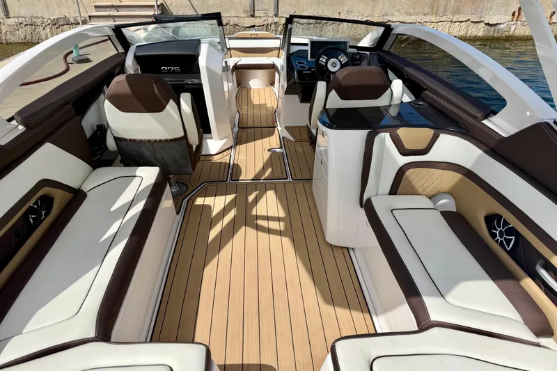 Slide: The Image of Luxurious interior of 2022 Yamaha Boats 275SD with elegant seating and modern dashboard. - 18