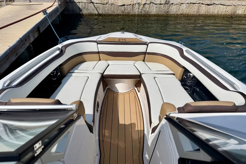 Slide: The Image of 2022 Yamaha Boats 275SD interior with luxurious seating and teak flooring. - 19