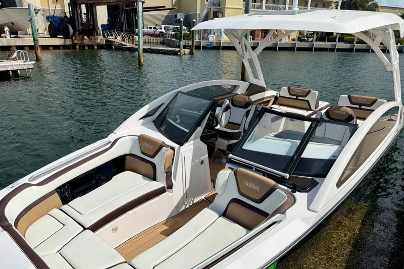 Slide: The Image of 2022 Yamaha Boats 275SD luxury boat with spacious seating and sleek design on the water. - 20