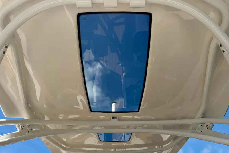 Slide: The Image of 2022 Yamaha Boats 275SD sunroof view with clear blue sky reflection. - 21