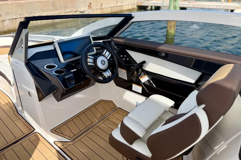 Slide: The Image of 2022 Yamaha Boats 275SD cockpit with modern steering and digital display. - 22