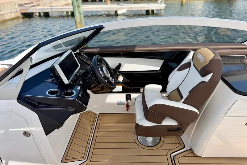Slide: The Image of 2022 Yamaha Boats 275SD helm with modern controls and luxurious seating. - 23
