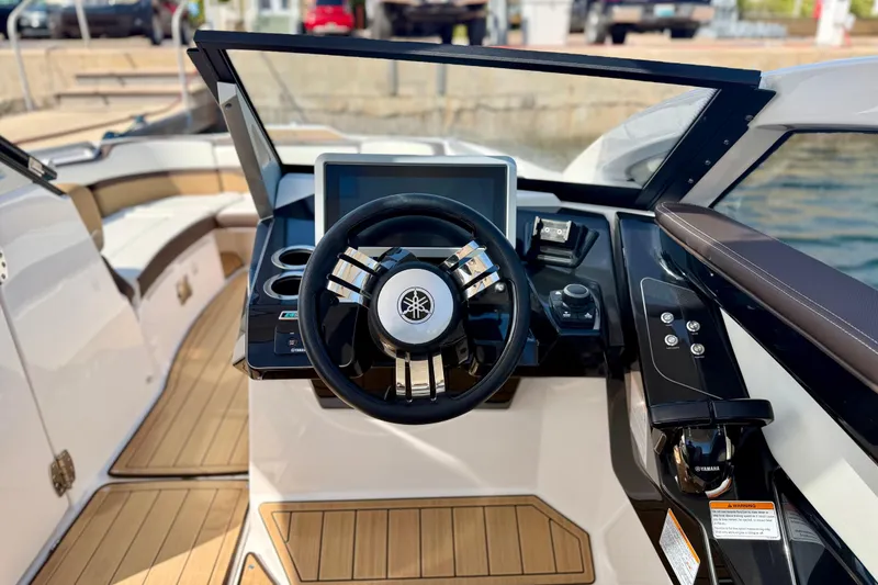Slide: The Image of 2022 Yamaha Boats 275SD helm with modern controls and sleek design. - 24