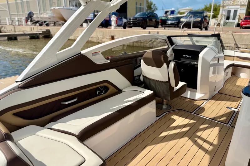 Slide: The Image of 2022 Yamaha Boats 275SD interior with luxurious seating and modern dashboard design. - 26