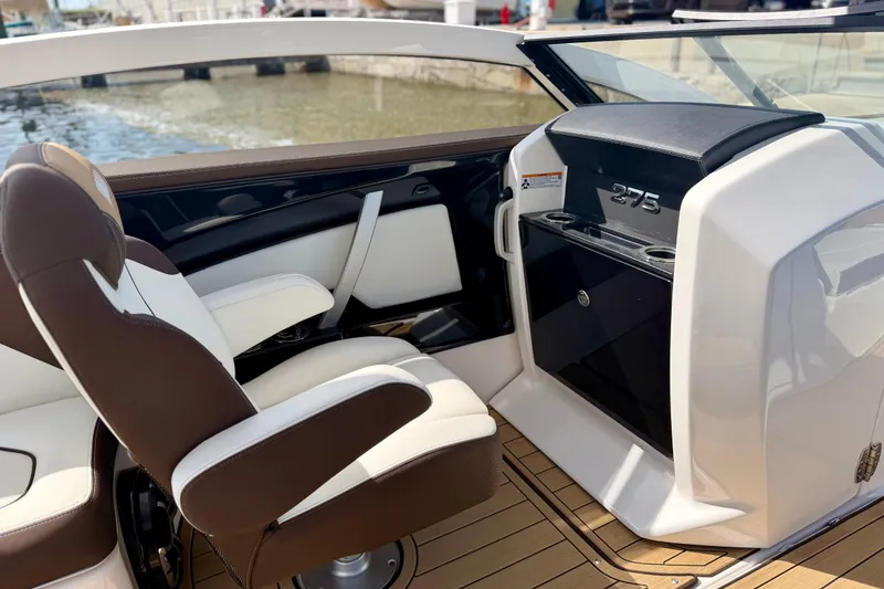 Slide: The Image of 2022 Yamaha Boats 275SD interior with luxurious seating and sleek dashboard design. - 29