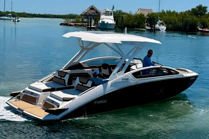 Slide: The Image of 2022 Yamaha Boats 275SD cruising on a serene waterway. - 3