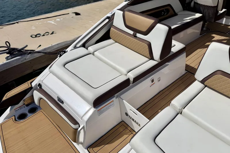 Slide: The Image of 2022 Yamaha Boats 275SD interior with luxurious seating and teak flooring. - 32