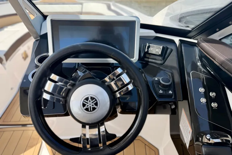 Slide: The Image of Steering wheel and dashboard of 2022 Yamaha Boats 275SD, featuring modern controls and touchscreen. - 34