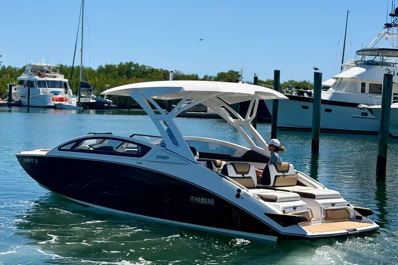 Slide: The Image of 2022 Yamaha Boats 275SD cruising in a marina, showcasing sleek design and luxury features. - 4