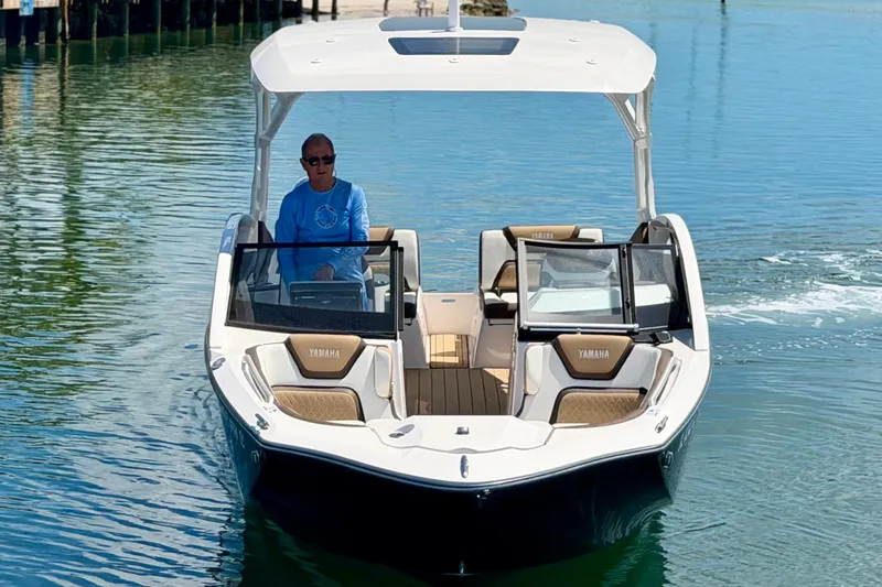 Slide: The Image of 2022 Yamaha Boats 275SD cruising on calm water, featuring sleek design and spacious seating. - 8