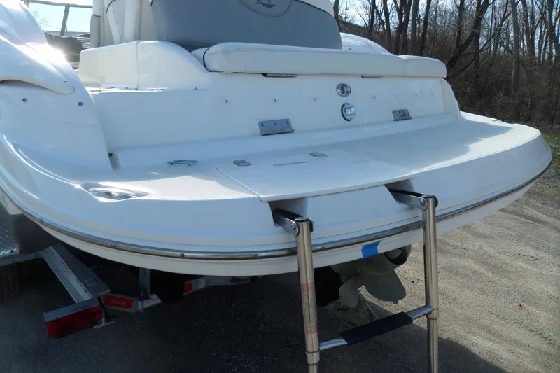 Slide: The Image of 2013 Rinker 296 Captiva Cuddy boat with swim platform and ladder. - 10