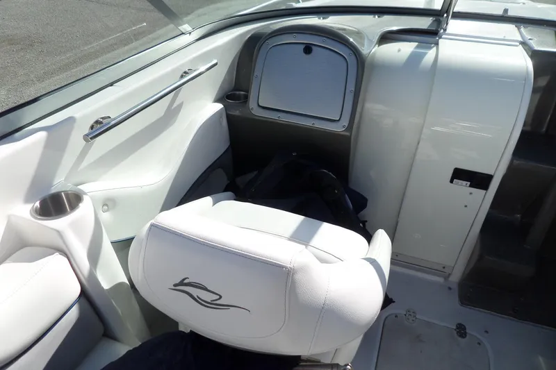 Slide: The Image of Interior of 2013 Rinker 296 Captiva Cuddy boat with white seating and storage compartment. - 12