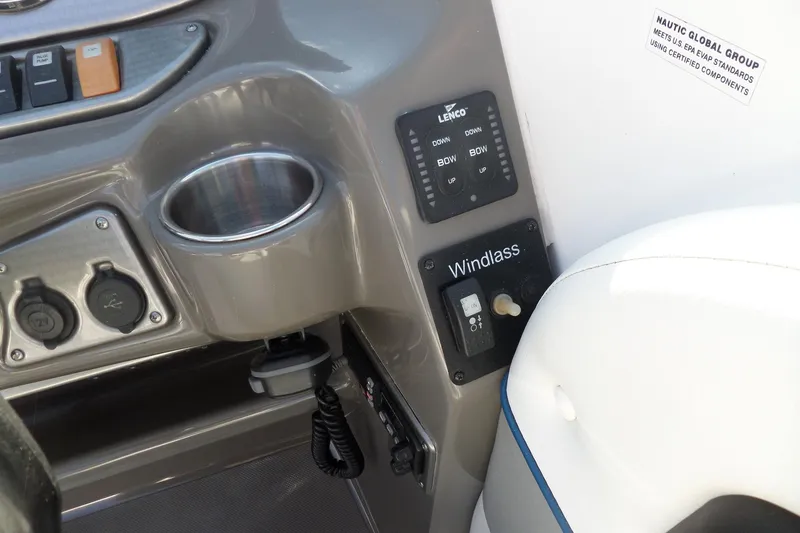 Slide: The Image of Control panel of 2013 Rinker 296 Captiva Cuddy boat with windlass switch and cup holder. - 15