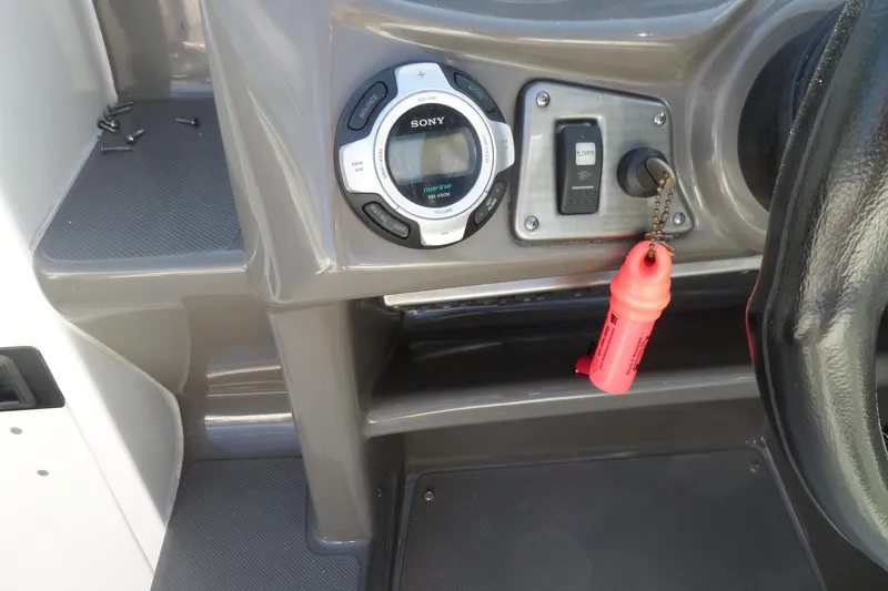 Slide: The Image of Dashboard of a 2013 Rinker 296 Captiva Cuddy with Sony marine audio system. - 16