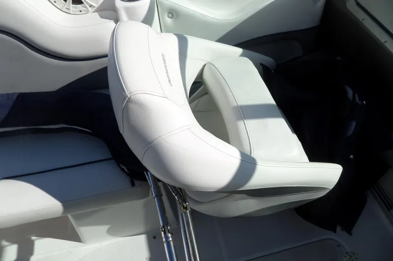 Slide: The Image of White leather seat on 2013 Rinker 296 Captiva Cuddy boat interior. - 17
