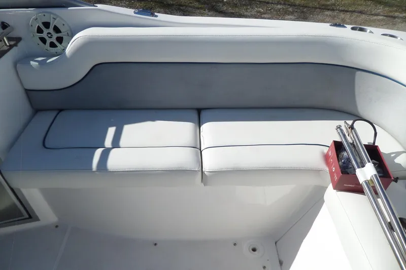 Slide: The Image of 2013 Rinker 296 Captiva Cuddy boat interior with white cushioned seating. - 20