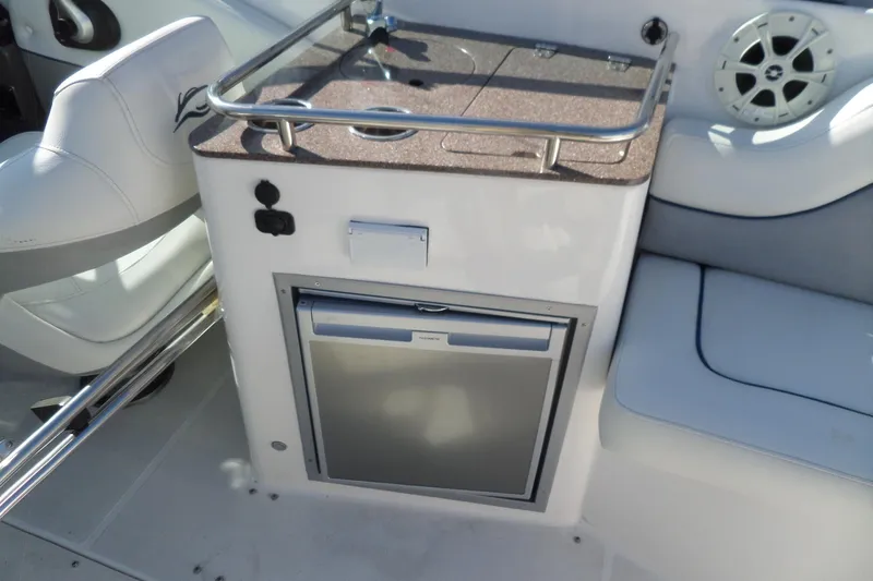 Slide: The Image of 2013 Rinker 296 Captiva Cuddy interior with mini fridge and seating area. - 21