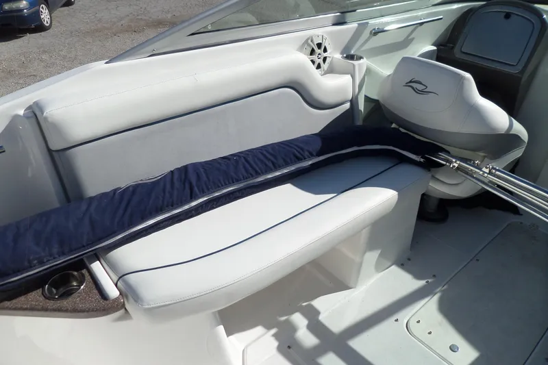 Slide: The Image of 2013 Rinker 296 Captiva Cuddy interior with white seating and steering area. - 22