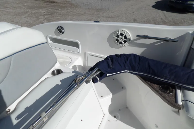 Slide: The Image of 2013 Rinker 296 Captiva Cuddy boat interior with seating and speaker. - 23