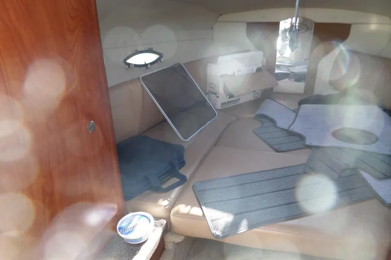 Slide: The Image of Interior of 2013 Rinker 296 Captiva Cuddy with seating and storage items. - 26