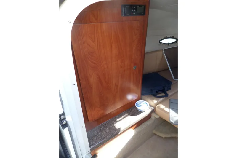 Slide: The Image of Interior of 2013 Rinker 296 Captiva Cuddy with wooden cabinetry and seating area. - 27