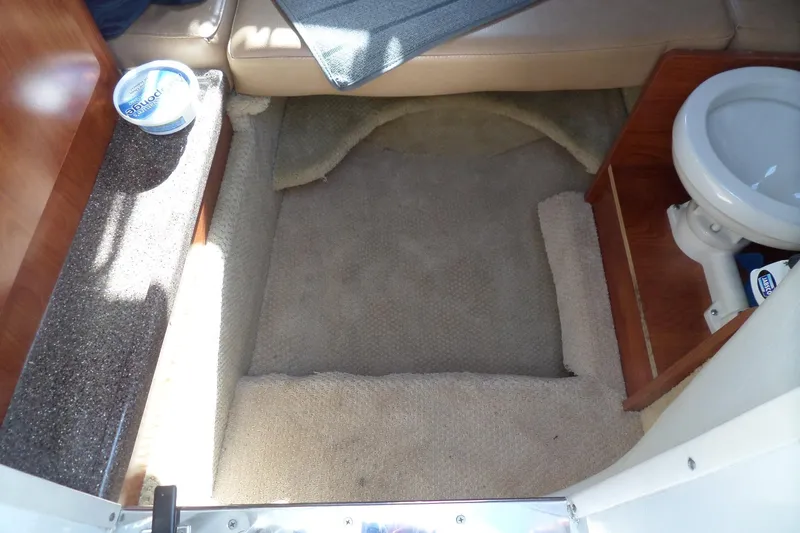 Slide: The Image of Interior of 2013 Rinker 296 Captiva Cuddy with carpeted floor and compact toilet. - 29