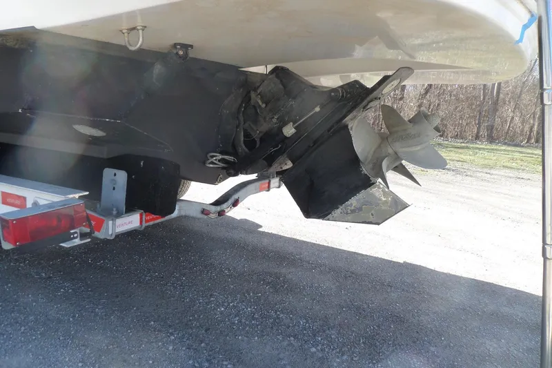 Slide: The Image of 2013 Rinker 296 Captiva Cuddy boat propeller and trailer detail. - 3