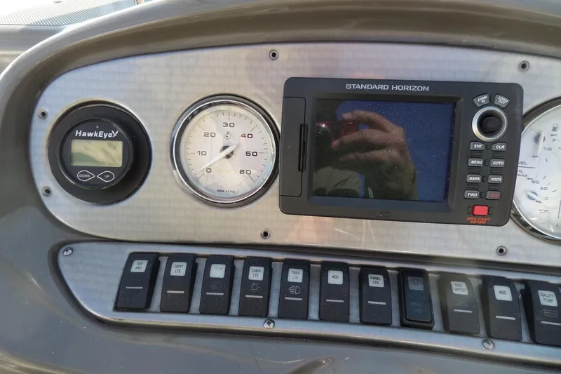 Slide: The Image of Dashboard of 2013 Rinker 296 Captiva Cuddy with gauges and navigation system. - 31