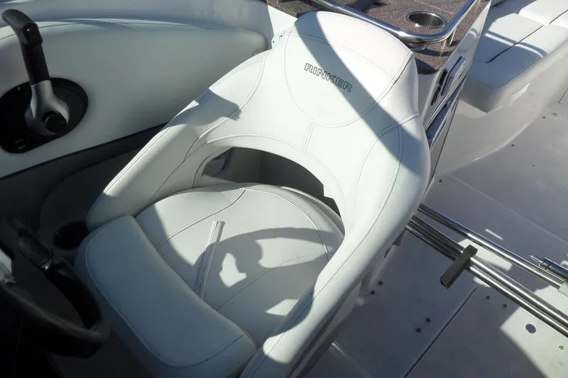 Slide: The Image of Captain's seat of 2013 Rinker 296 Captiva Cuddy boat, featuring sleek white upholstery. - 32