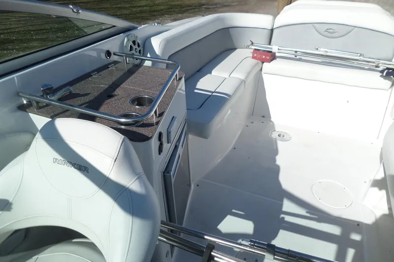Slide: The Image of 2013 Rinker 296 Captiva Cuddy interior with white seating and sleek design. - 33