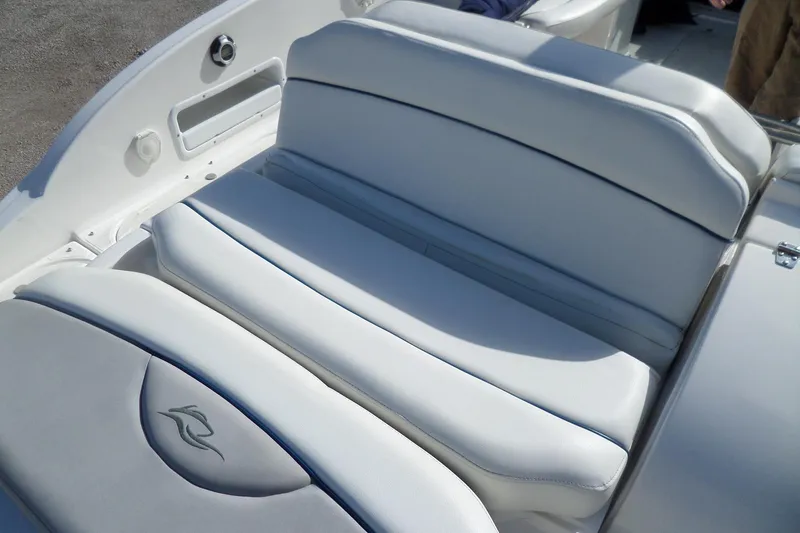 Slide: The Image of 2013 Rinker 296 Captiva Cuddy boat interior with white cushioned seating. - 36