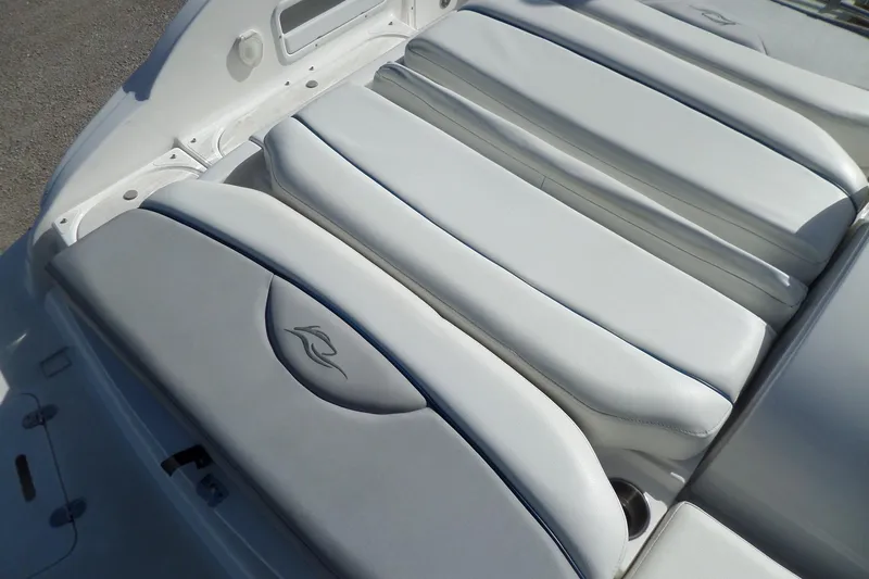 Slide: The Image of 2013 Rinker 296 Captiva Cuddy boat interior with white cushioned seating. - 37