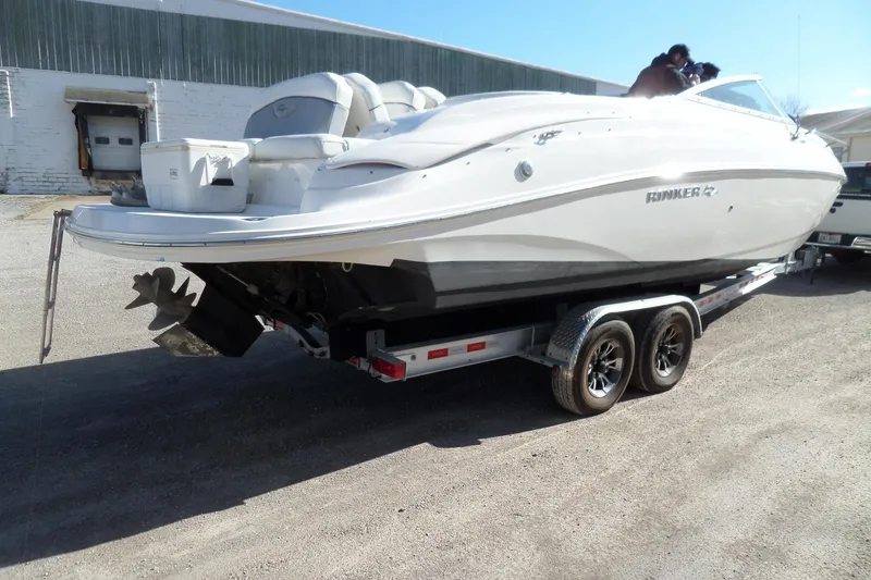 Slide: The Image of 2013 Rinker 296 Captiva Cuddy boat on trailer, parked outdoors. - 5
