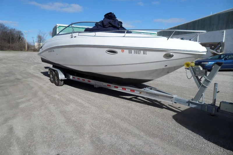 Slide: The Image of 2013 Rinker 296 Captiva Cuddy boat on trailer in outdoor setting. - 6