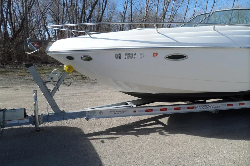 Slide: The Image of 2013 Rinker 296 Captiva Cuddy boat on trailer, parked outdoors. - 9