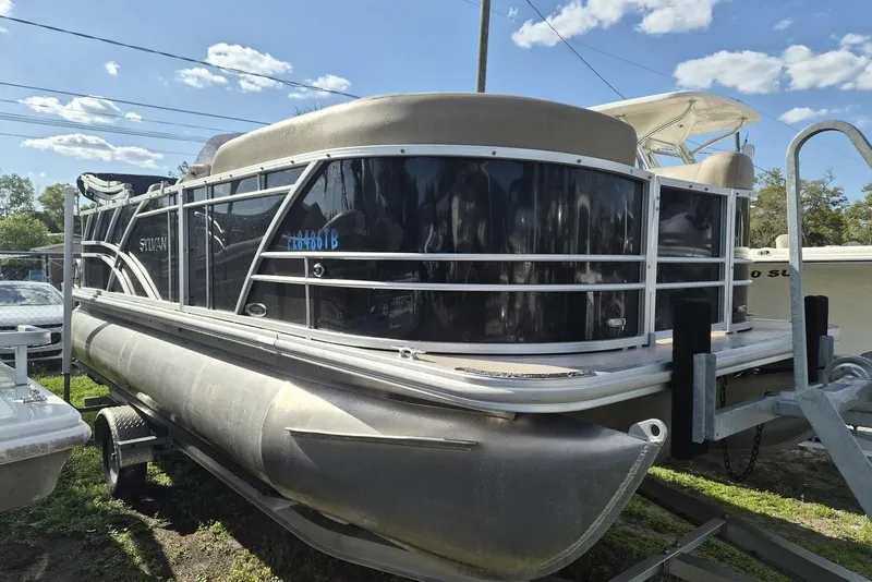 The Image of 2022 Sylvan Mirage Fish 820 Party Fish pontoon boat on trailer under blue sky. - 1