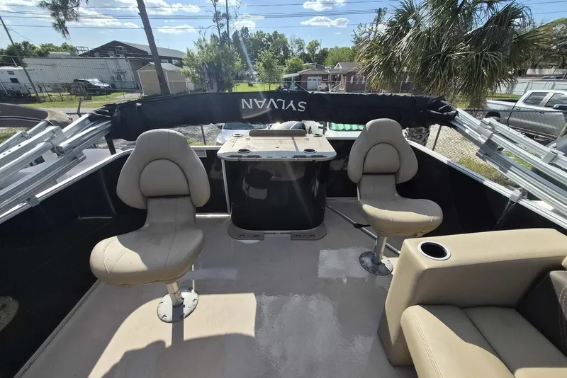 Slide: The Image of 2022 Sylvan Mirage Fish 820 Party Fish boat interior with seating and table. - 10