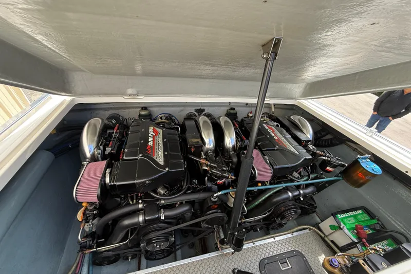 Slide: The Image of Engine compartment of a 1997 Powerplay Powerboats 33 Sport Deck, showcasing dual high-performance engines. - 10