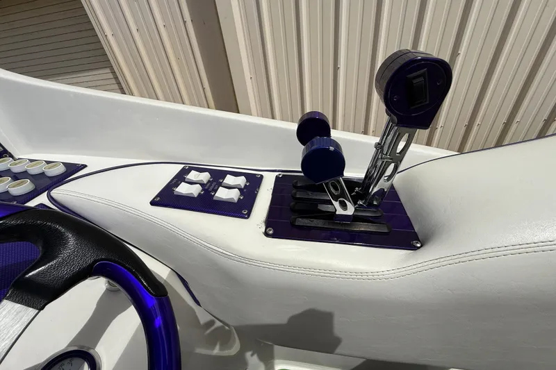Slide: The Image of 1997 Powerplay Powerboats 33 Sport Deck throttle controls and dashboard detail. - 13